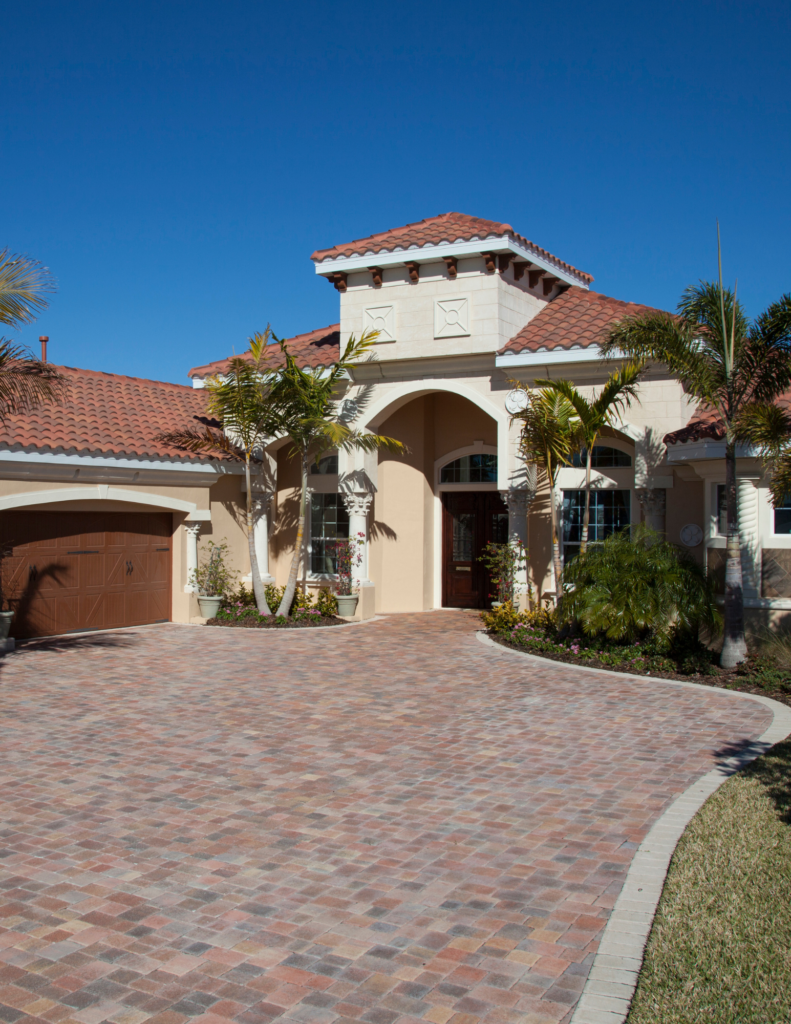 Mediterranean House with paver driveway palm trees